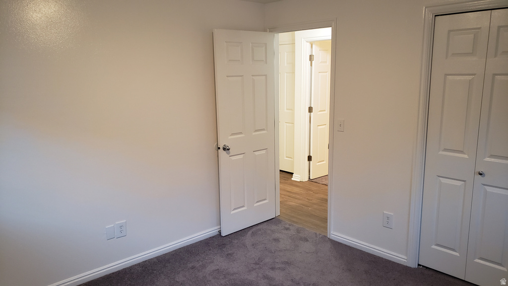 Unfurnished bedroom with carpet and a closet