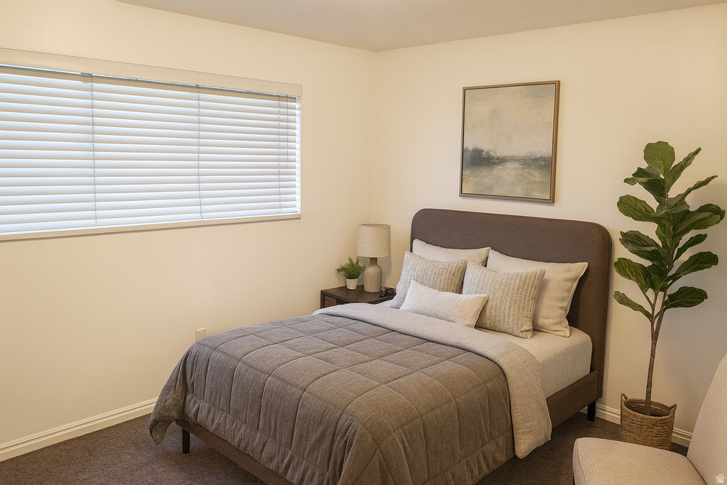 Bedroom with baseboards and carpet