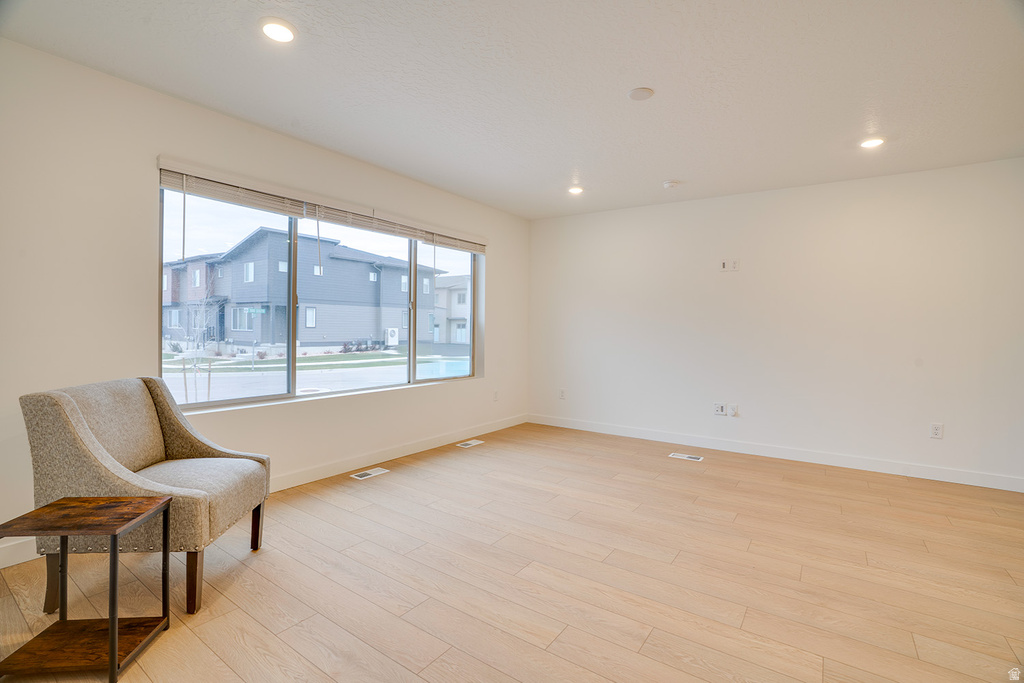 Unfurnished room with light wood finished floors and recessed lighting