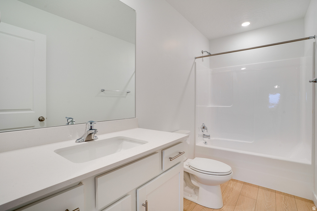Bathroom with vanity, bathtub / shower combination, and light wood finished floors