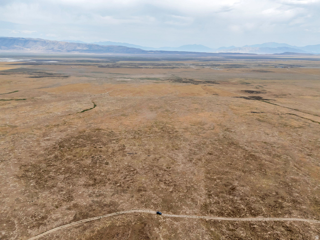 Aerial view of sparsely populated area with a mountainous background and a desert landscape