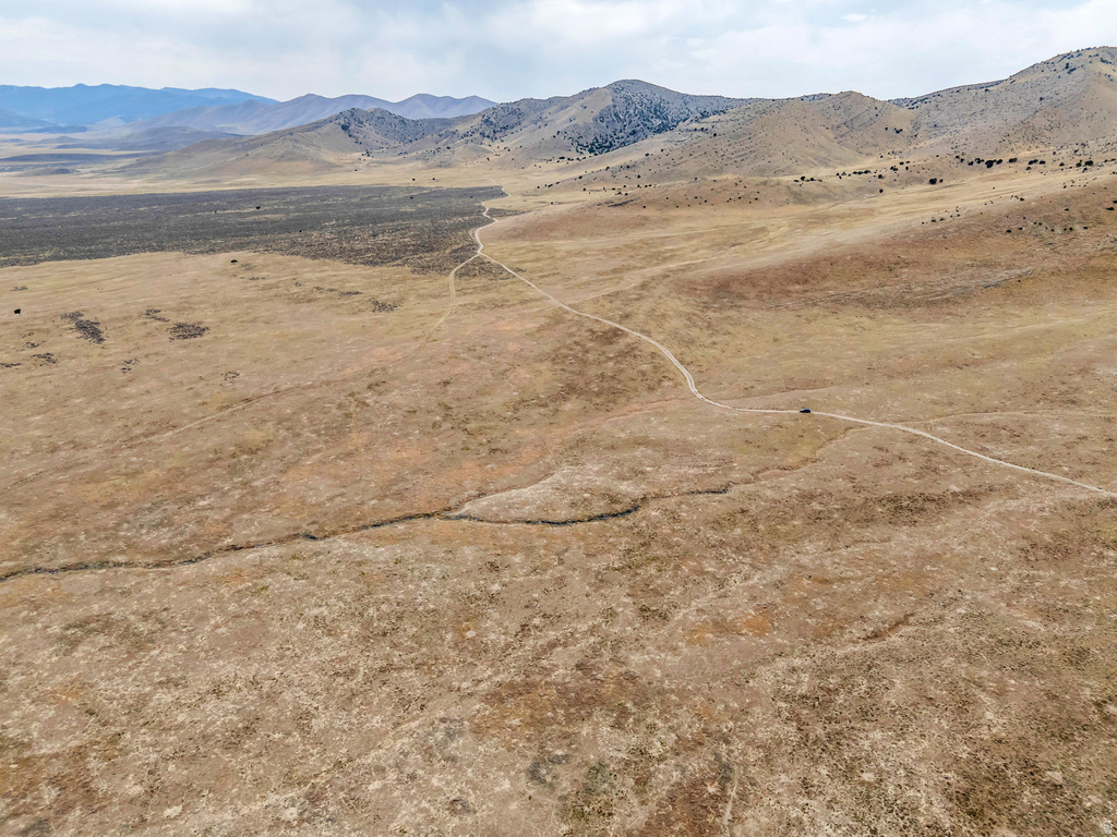 View of mountain backdrop with rural landscape