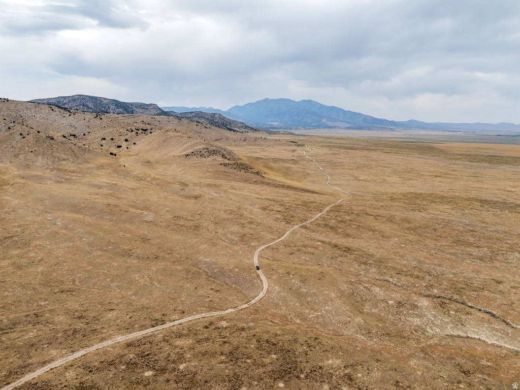 View of mountain backdrop with rural landscape