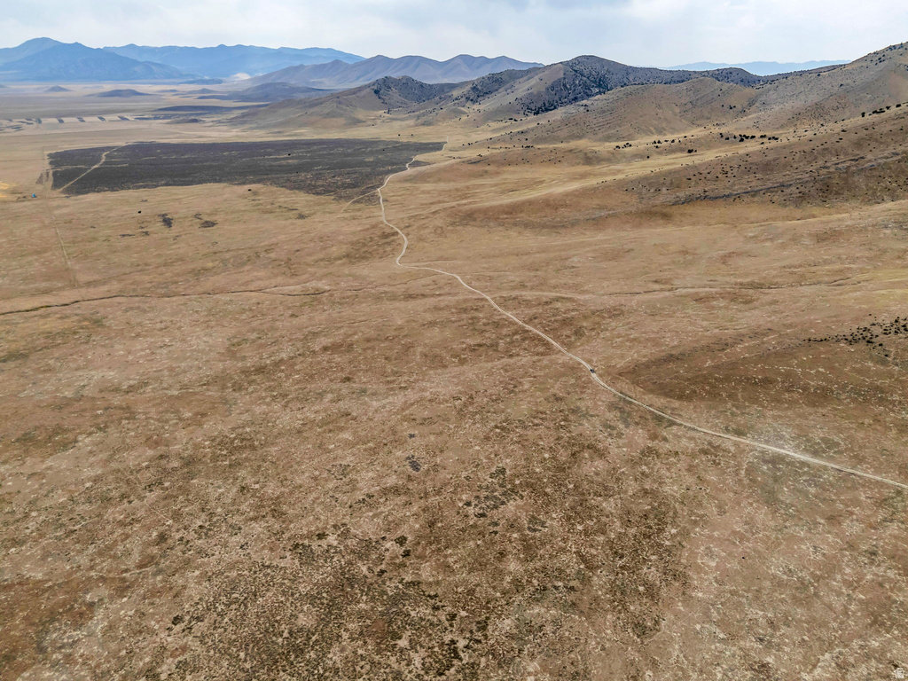 View of mountain backdrop with rural landscape