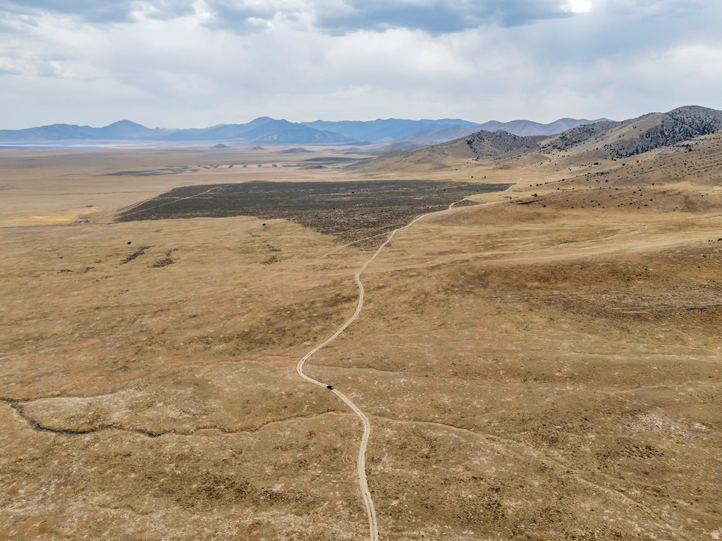 View of mountain backdrop with rural landscape