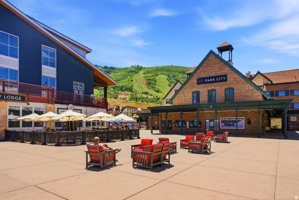 Expansive outdoor plaza featuring a brick and timber-clad building with a prominent sign