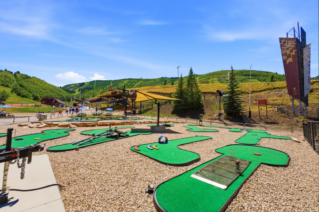 Miniature golf course with multiple green turf putting areas and gravel surrounds