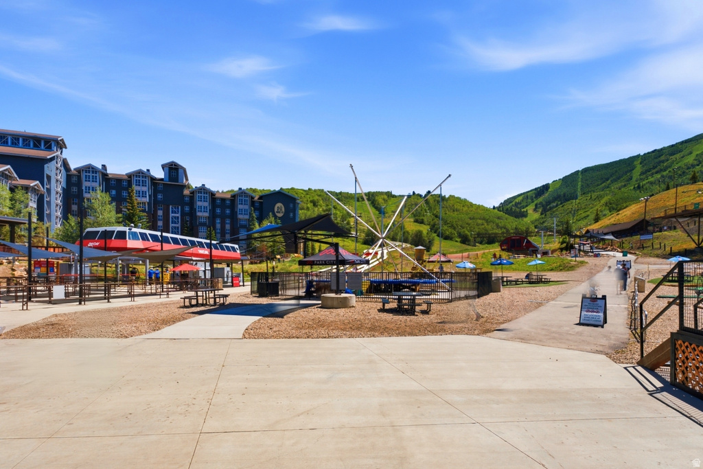 Mountain resort setting featuring multi-story buildings with dark siding and multiple windows