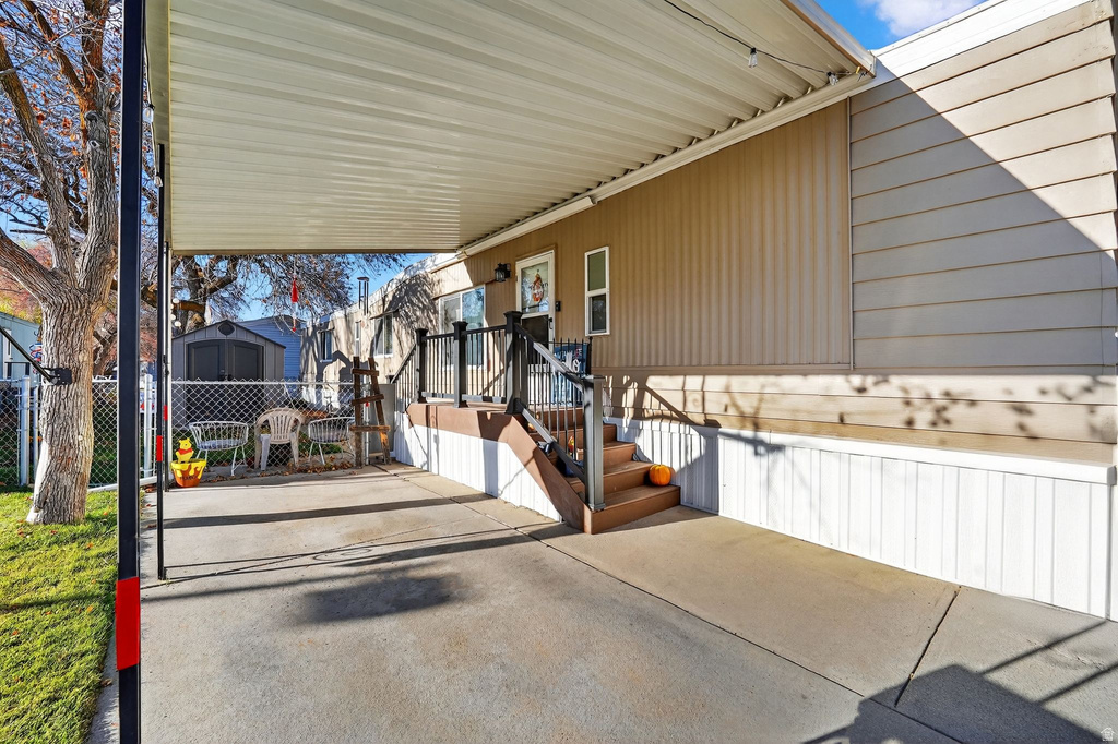 View of patio with a shed and an attached carport