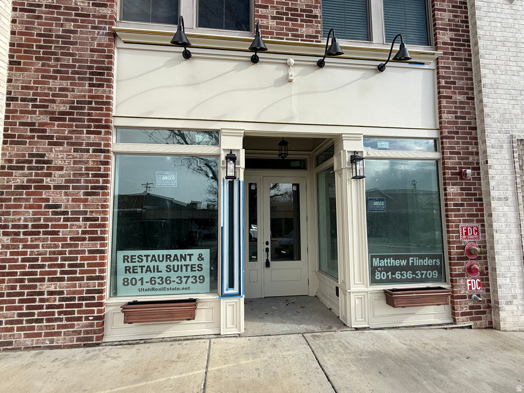 View of exterior entry with brick siding