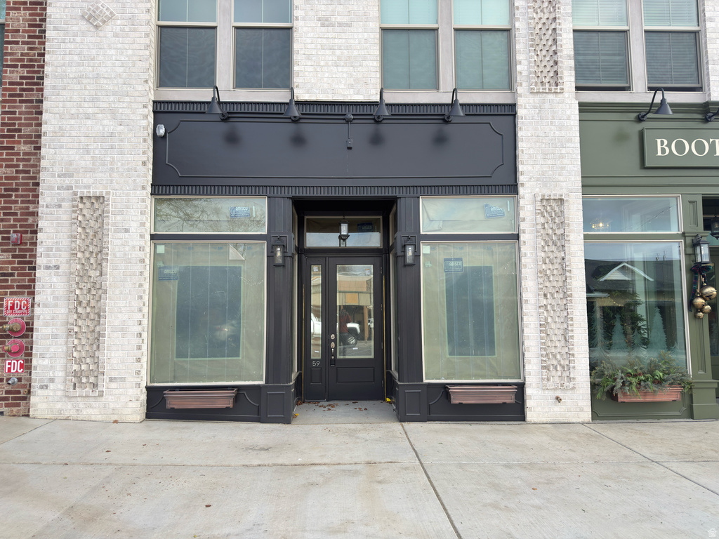 View of exterior entry with brick siding