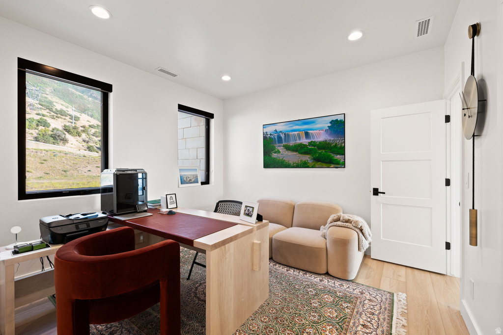Office space featuring light wood-style floors and recessed lighting