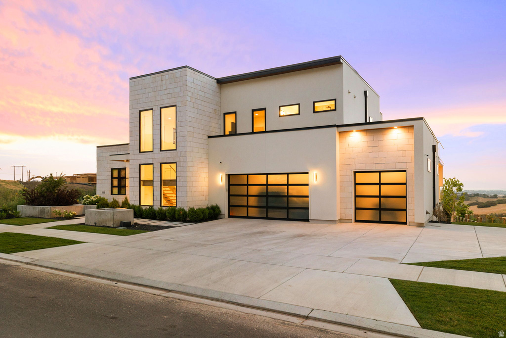 Contemporary home with driveway and stucco siding