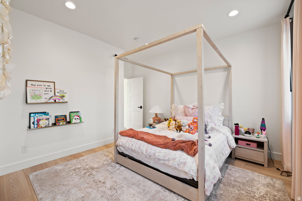 Bedroom with light wood finished floors and recessed lighting