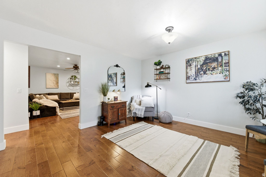 Living area with hardwood / wood-style flooring, a ceiling fan, and recessed lighting