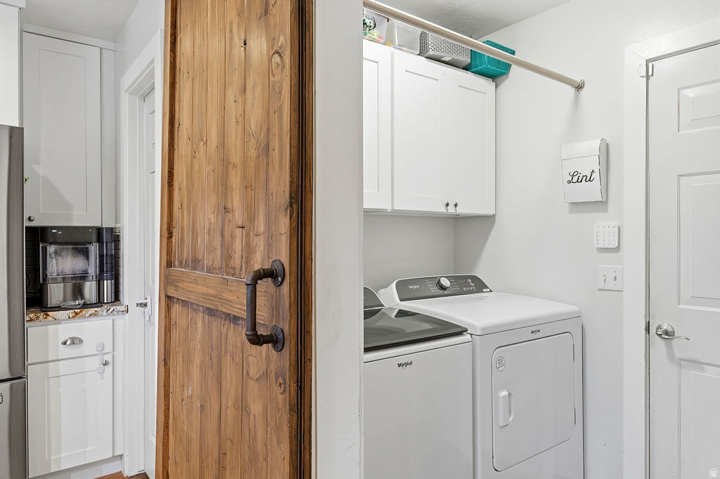 Washroom with cabinet space and washer and dryer