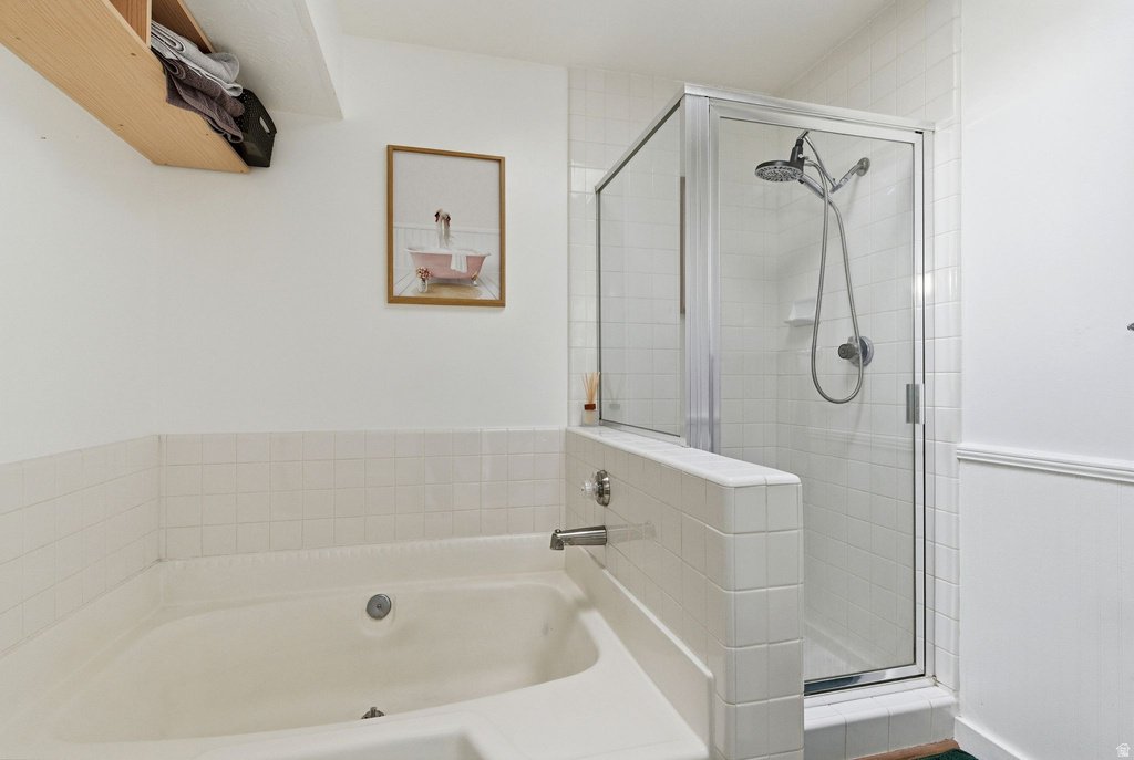 Full bath with a bath and a shower stall