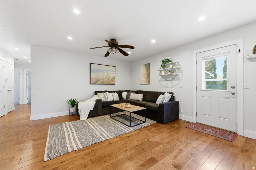 Living room with recessed lighting, light wood finished floors, and ceiling fan