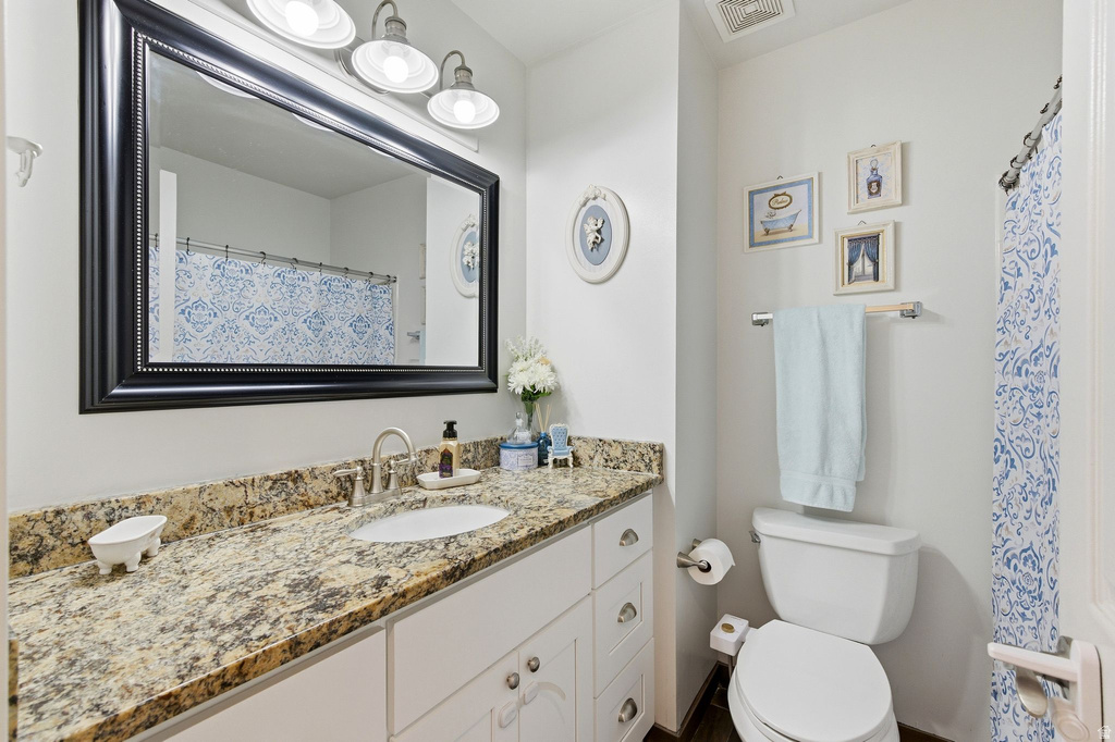 Bathroom with vanity and curtained shower
