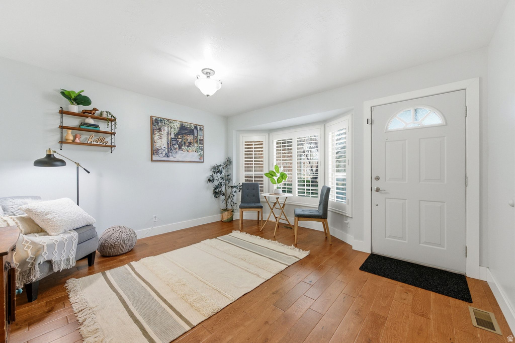 Foyer with baseboards and light wood finished floors