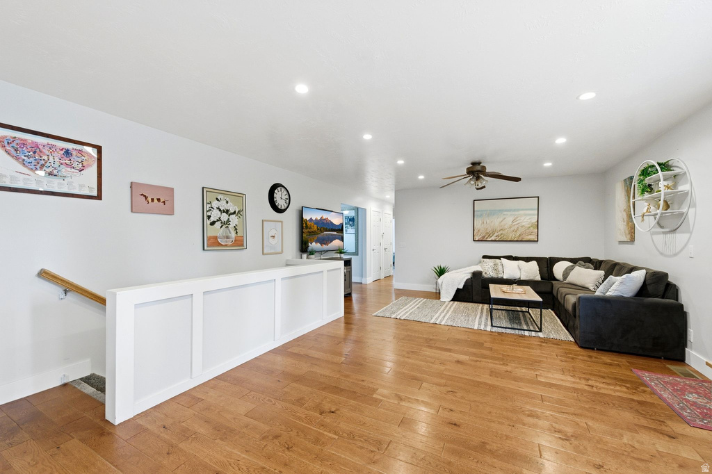 Living area with light wood-type flooring, ceiling fan, and recessed lighting