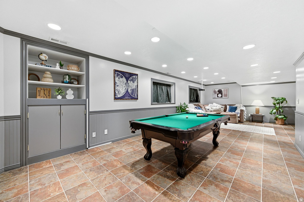 Rec room with wainscoting, billiards, crown molding, built in shelves, and recessed lighting