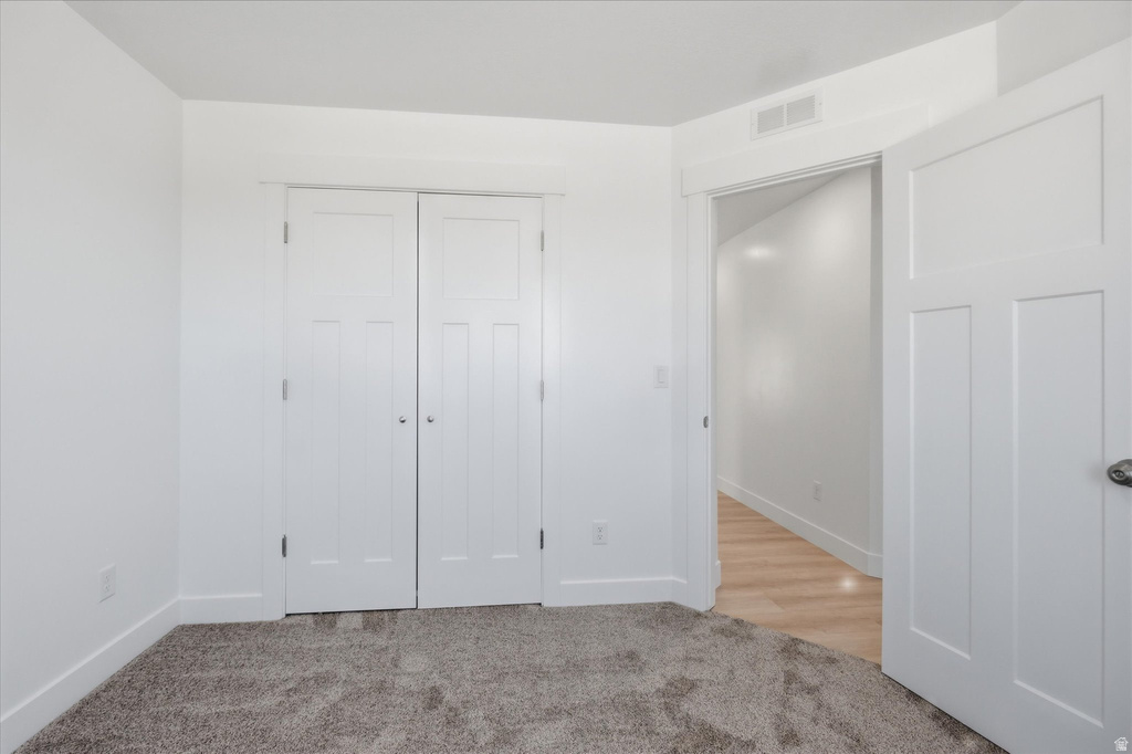 Neutral-toned carpeting extends across the floor, complemented by crisp white walls and trim