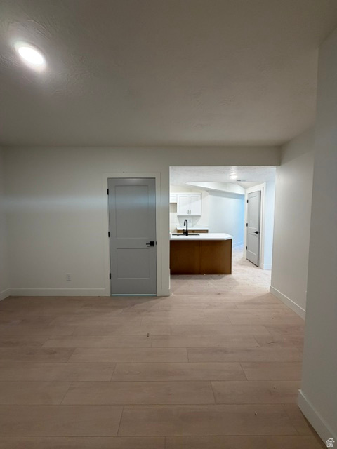 Open-concept living space featuring light wood-finish flooring throughout