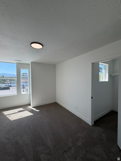 Room featuring carpet flooring, white painted walls, and a flush-mount ceiling light