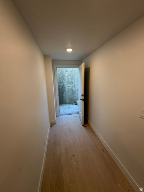 Entryway featuring light wood-finish flooring, white baseboards, and a recessed ceiling light