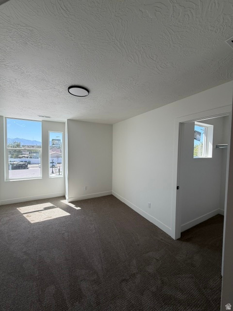 Spacious interior room with neutral-toned carpet flooring