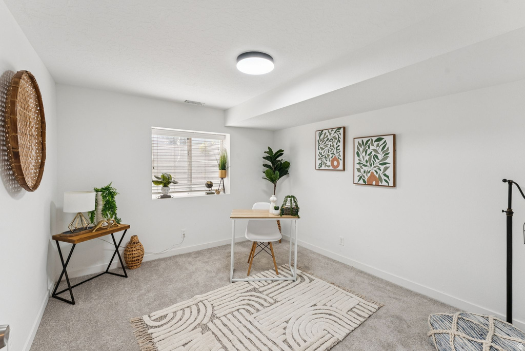 Office space with carpet and baseboards
