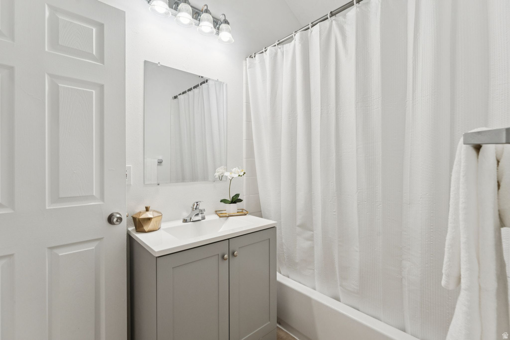 Full bath featuring vanity and shower / bath combo with shower curtain