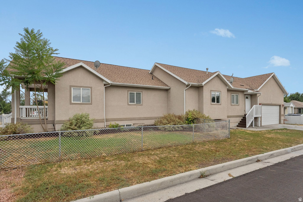 Ranch-style home featuring stucco siding and roof with shingles