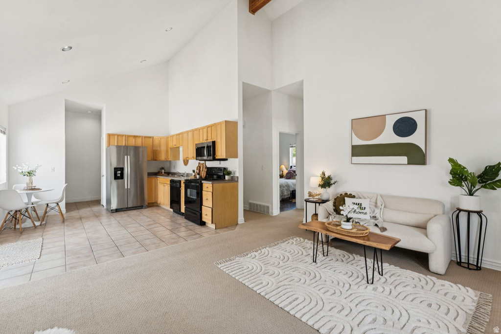 Living area with light colored carpet, light tile patterned floors, lofted ceiling, and recessed lighting