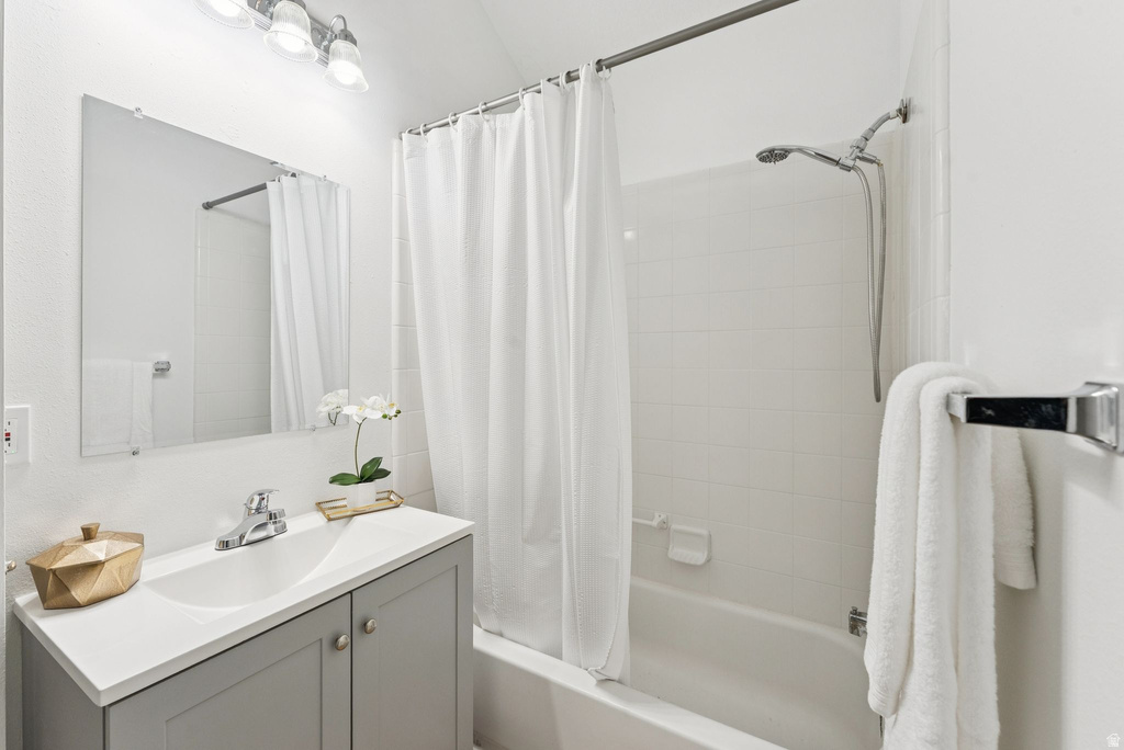 Full bath featuring shower / bathtub combination with curtain and vanity
