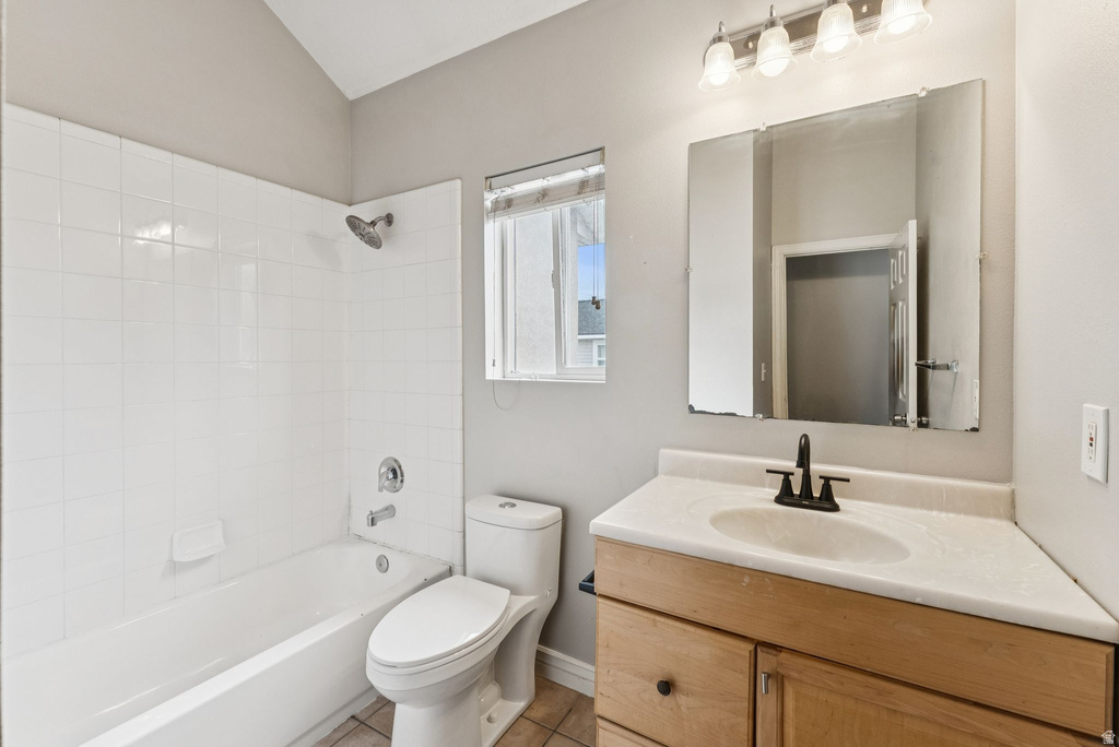 Full bathroom with bathtub / shower combination, vanity, and tile patterned floors