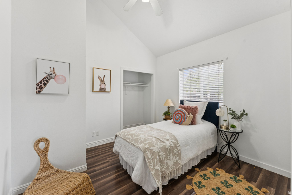 Bedroom featuring vaulted ceiling, dark wood-style floors, a closet, and ceiling fan