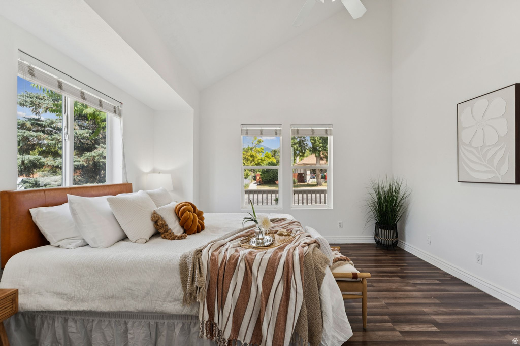 Bedroom featuring vaulted ceiling, dark wood finished floors, and a ceiling fan