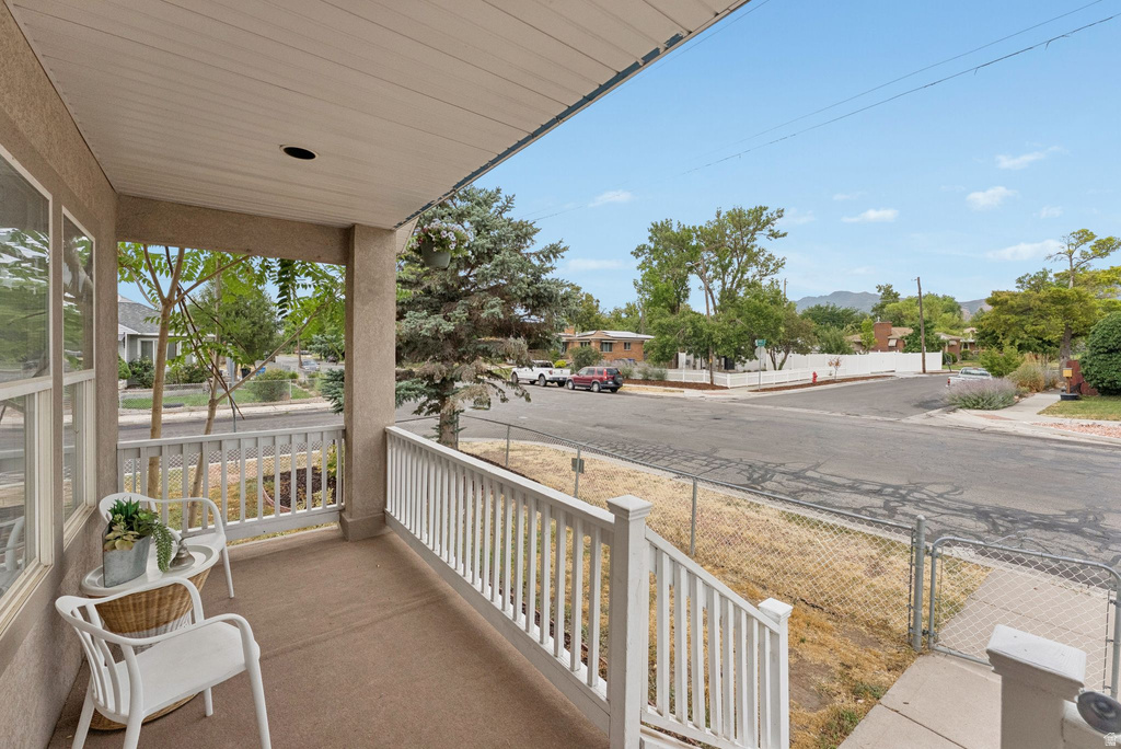 Covered porch with a sunroom and a residential view