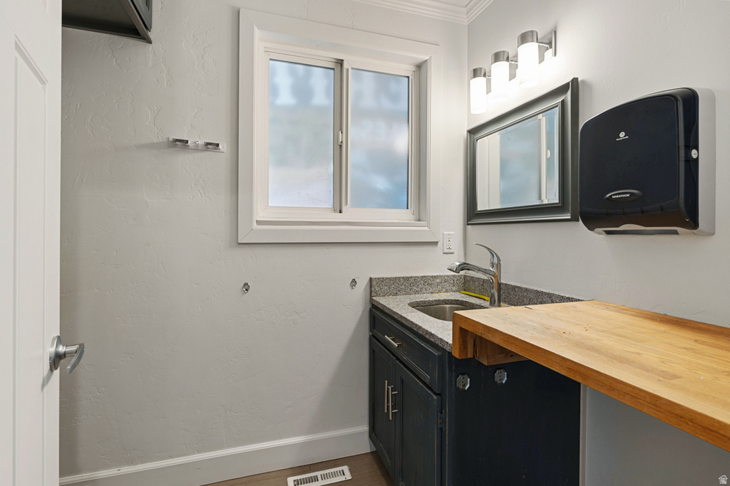 Bathroom featuring vanity and baseboards