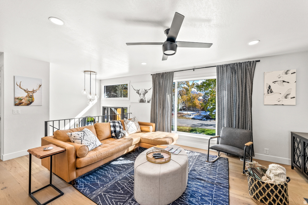 Living room featuring light wood finished floors, ceiling fan, and recessed lighting