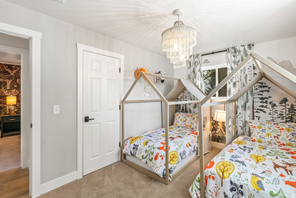 Bedroom featuring carpet and hanging lights