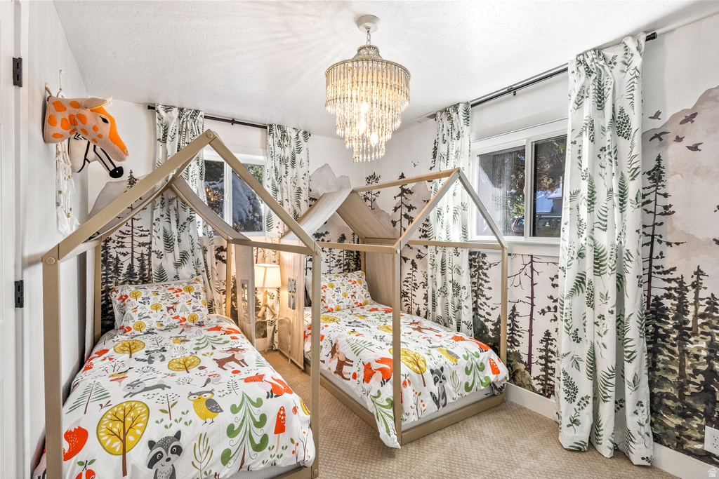 Bedroom featuring carpet floors and hanging lights