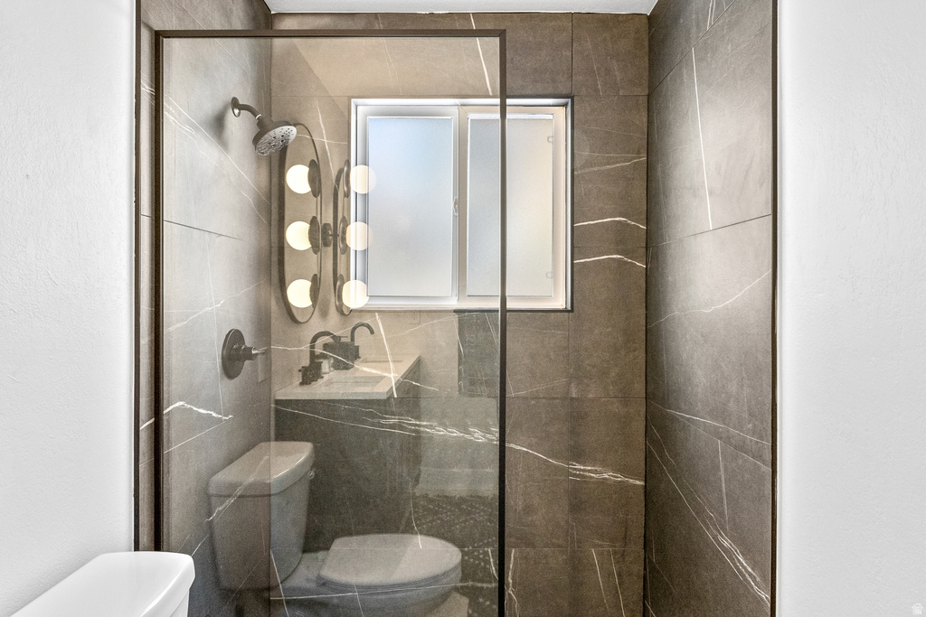 Bathroom featuring toilet and a shower stall