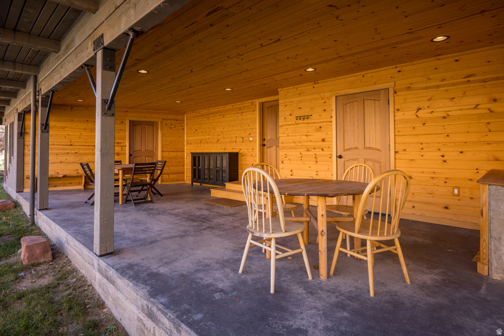 Dining space with wooden walls, wooden ceiling, and recessed lighting