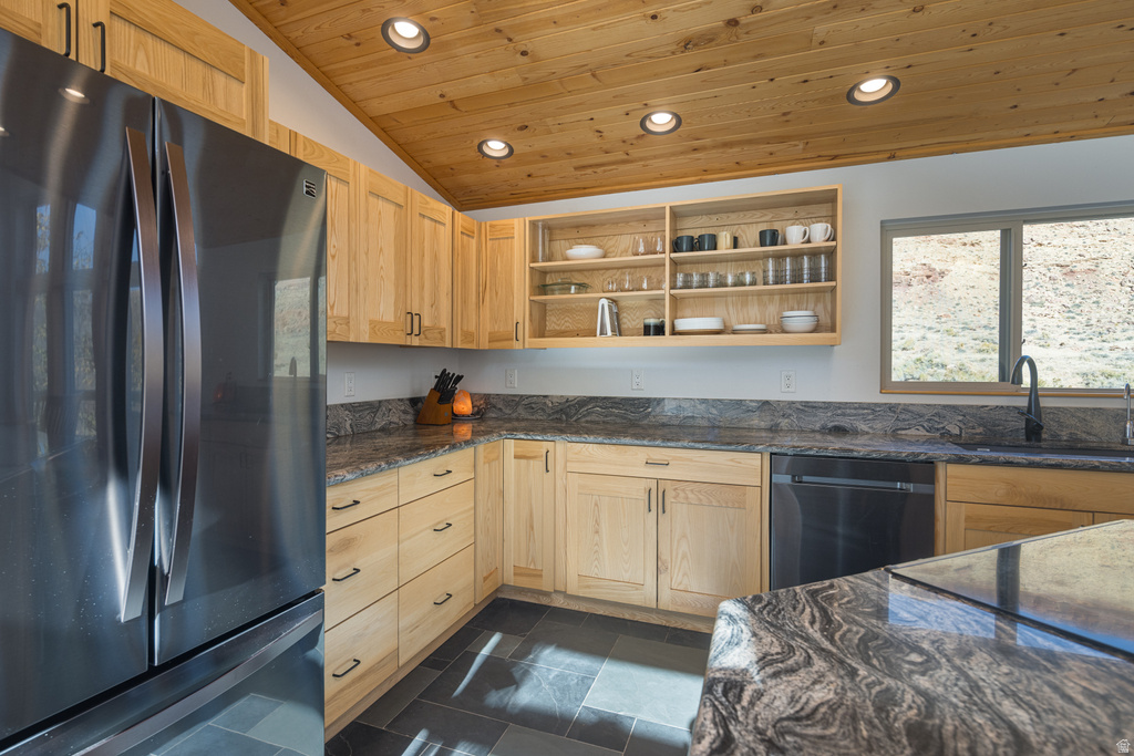 Kitchen featuring open shelves, freestanding refrigerator, recessed lighting, dark stone counters, and dishwasher