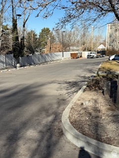 View of asphalt street with curbs