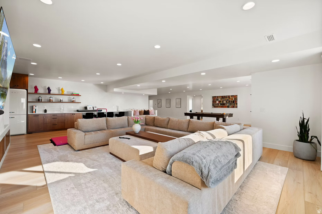 Living room with light wood-style floors and recessed lighting