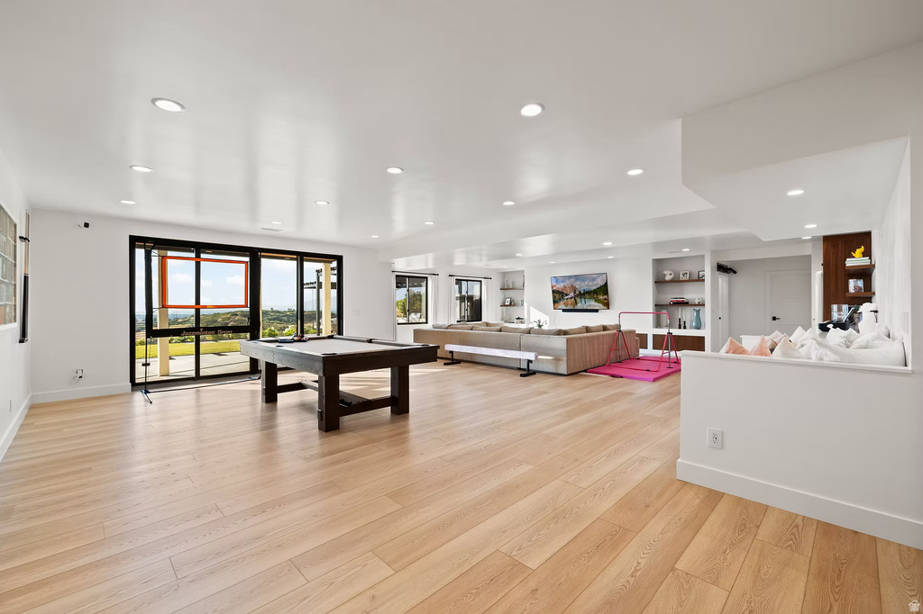 Game room with light wood-style flooring, pool table, and recessed lighting
